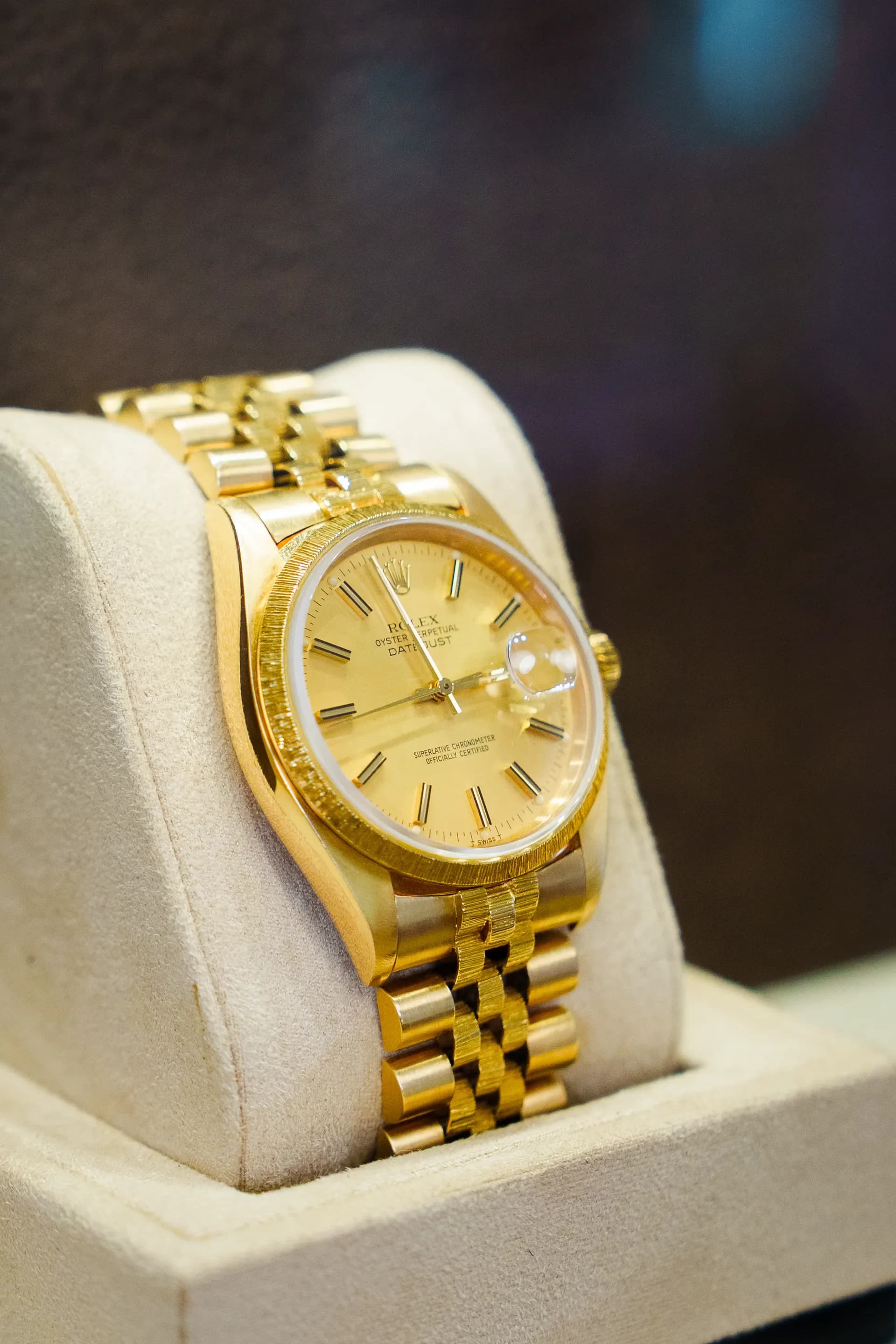 Goldene Rolex Datejust auf dem Uhrenkissen